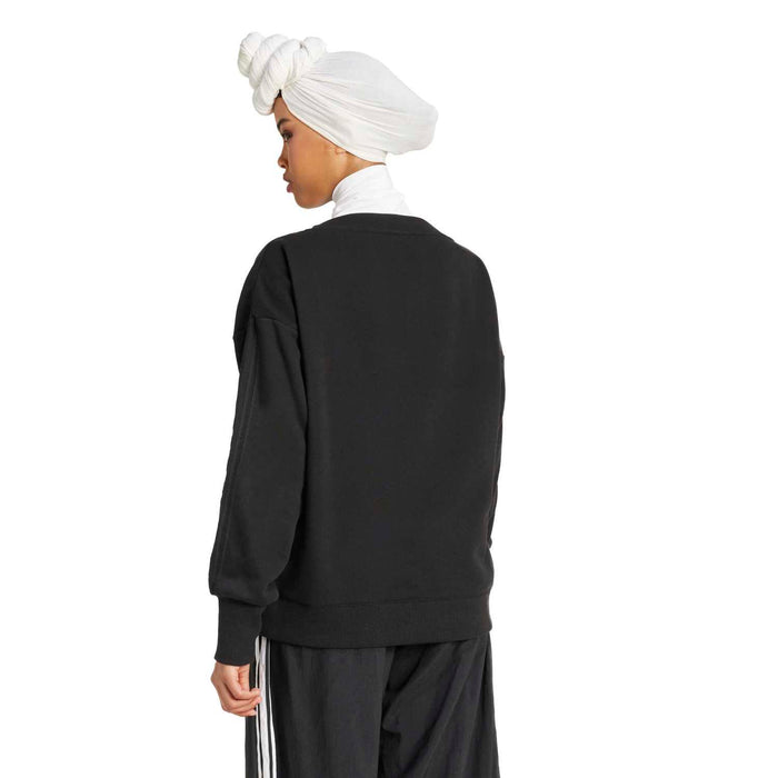 Black loose sweatshirt rear view, crew neckline, long sleeves with ribbed cuffs