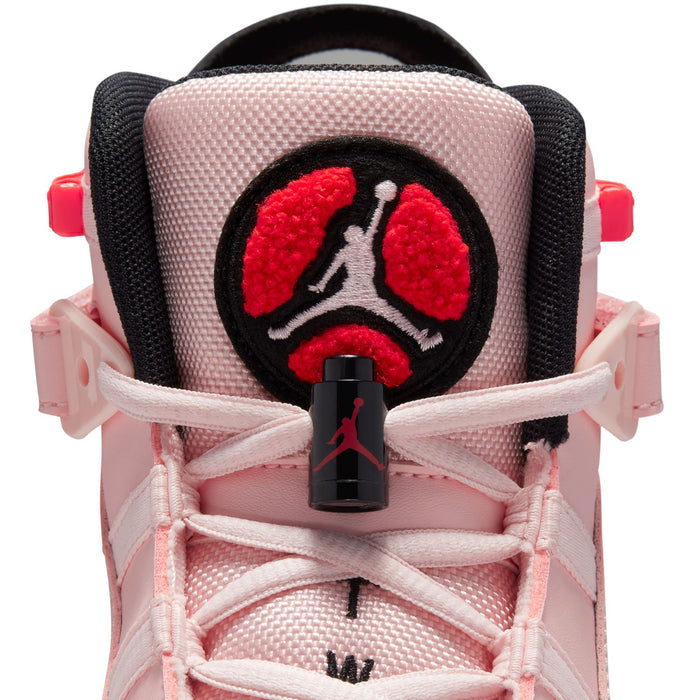 Close-up of pink sneaker heel with black circular patch and red Jumpman graphic