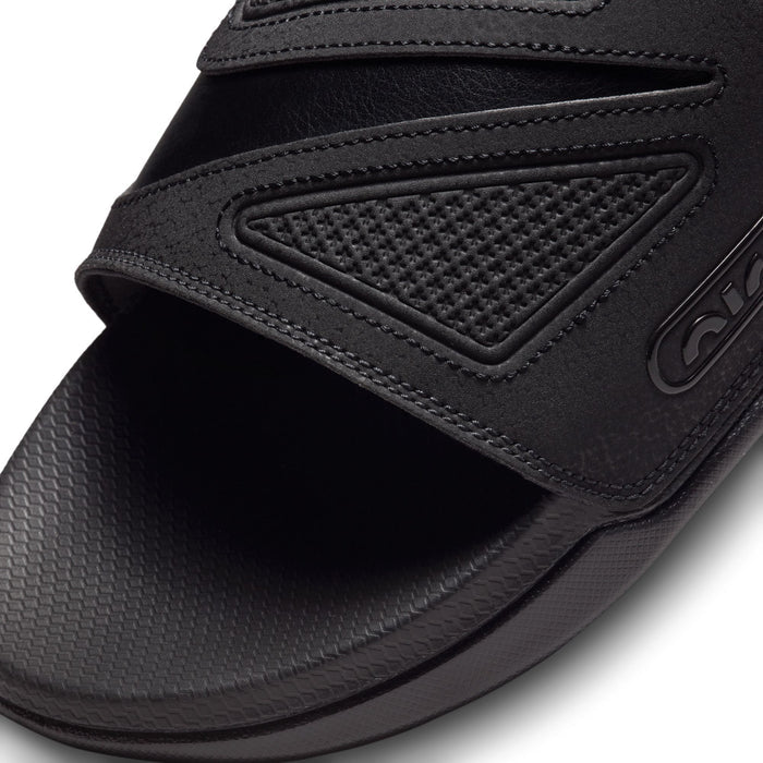 Black slide sandal upper close-up with perforated panel and stitched edges