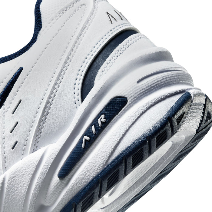 Men's white sneaker side with navy accents and ribbed Air midsole detail