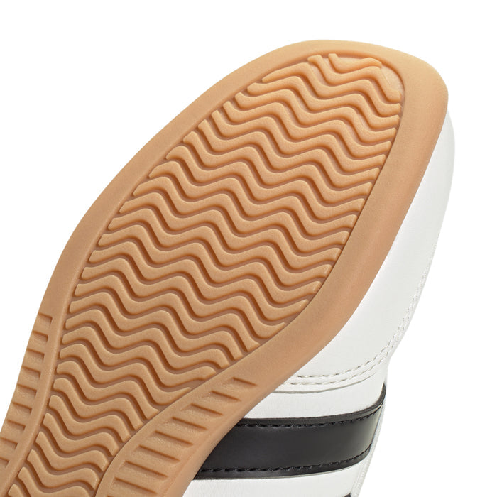 Youth Mary Jane sneaker outsole close-up, tan wavy traction tread on gum sole.