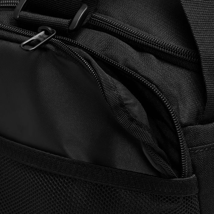 Close-up of black Nike duffel bag with multiple zippers and textured fabric
