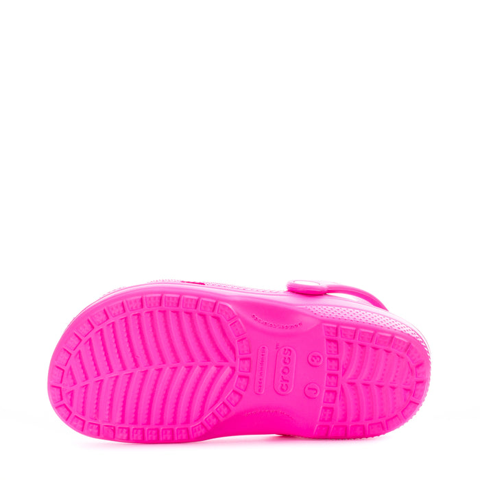 Kids' pink clog outsole view with treaded sole and 'crocs' logo