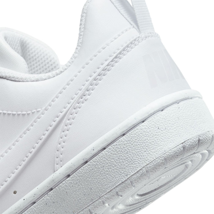 White sneaker side close-up with Nike swoosh detail and textured midsole