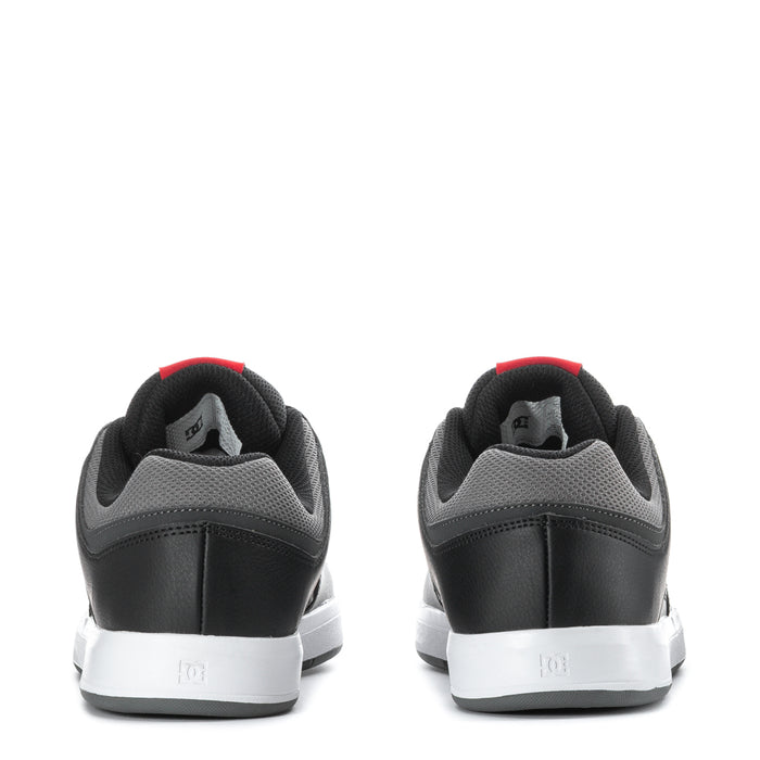 Men's black sneakers heel view with red DC tab and cushioned collar