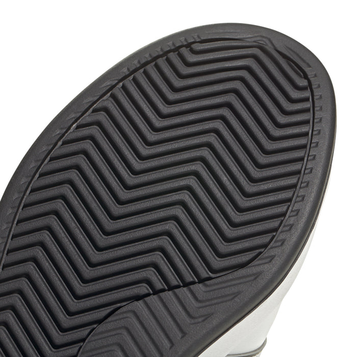 Men's adidas outsole close-up with deep chevron tread for traction.