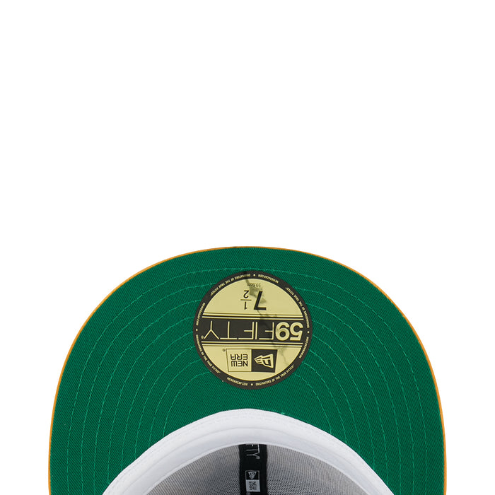 Green cap underside with circular interior label and stitched brim edge