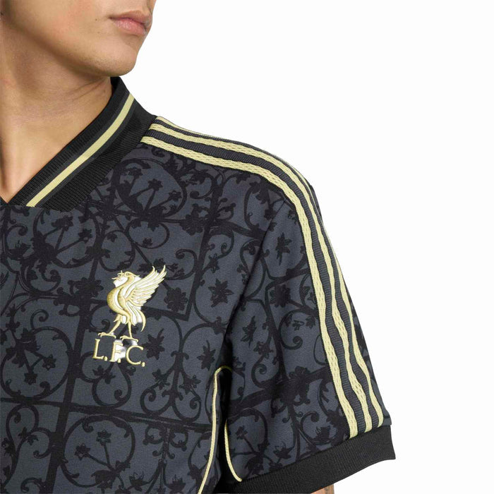 Men's navy Liverpool jersey sleeve close-up with gold trim stripes and LFC crest.
