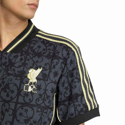 Men's navy Liverpool jersey sleeve close-up with gold trim stripes and LFC crest.