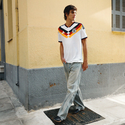 Men's Germany home soccer jersey, white with multicolor V graphic and team crest