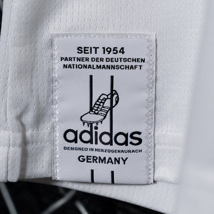 White inner label patch with adidas logo and text "DEUTSCHER NATIONALMANNSCHAFT"