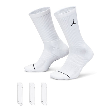 Three-pack white crew socks with black Jumpman logo, ribbed cuff and knit texture