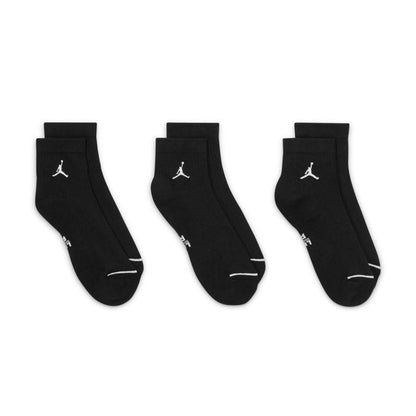 Three black quarter socks with white Jumpman logos and light trim on toe