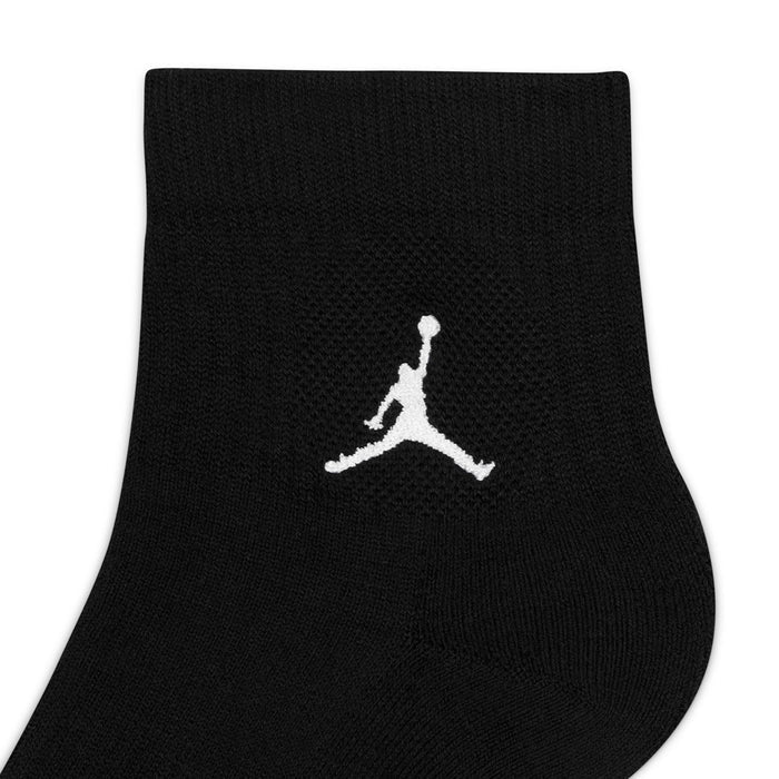 Close-up of black quarter sock with white Jumpman logo on the ankle
