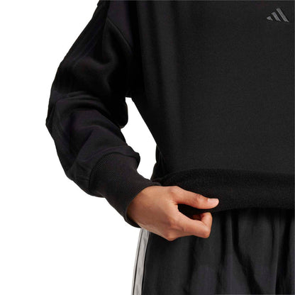 Black loose sweatshirt detail: ribbed sleeve cuff and straight hem