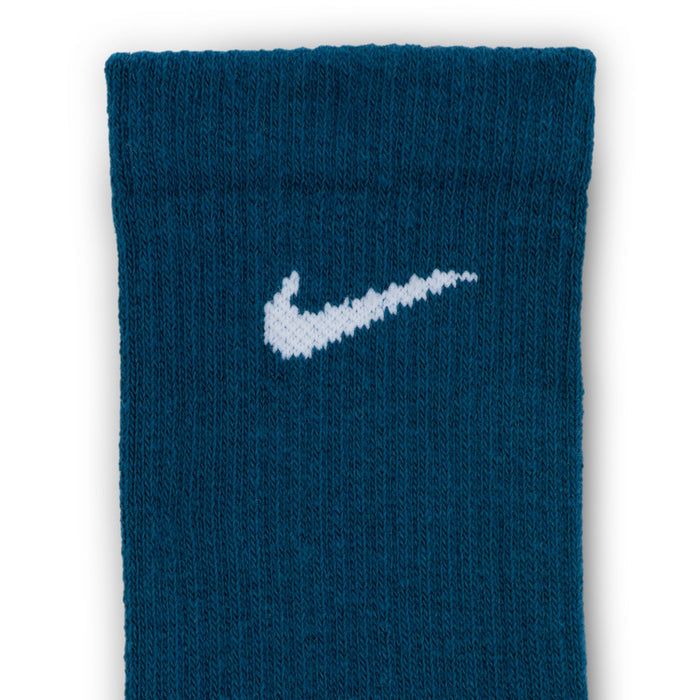 Unisex crew sock close-up with white Nike swoosh on dark blue knit