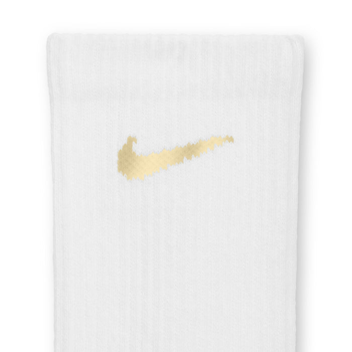 White crew sock with gold Nike Swoosh on knit fabric
