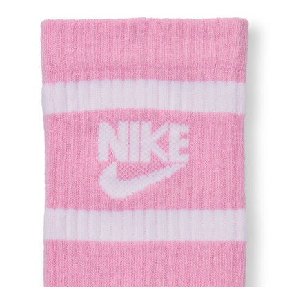 Youth crew socks close-up, pink with white Nike swoosh and stripe bands