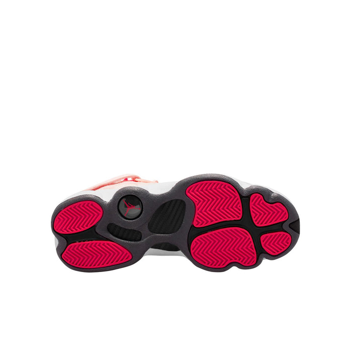 Outsole for youth pink sneakers with black tread and red traction pods