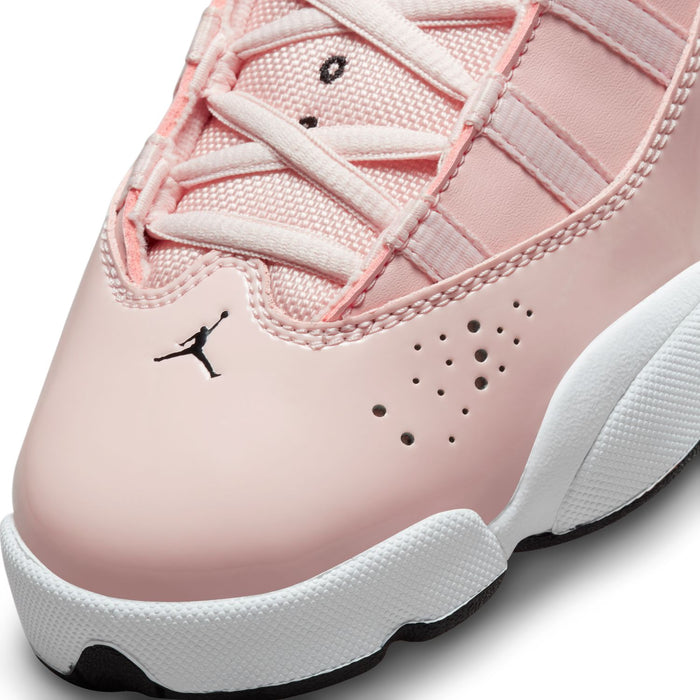 Close-up of pink sneaker toe with perforations, stitched seams, and black Jordan logo