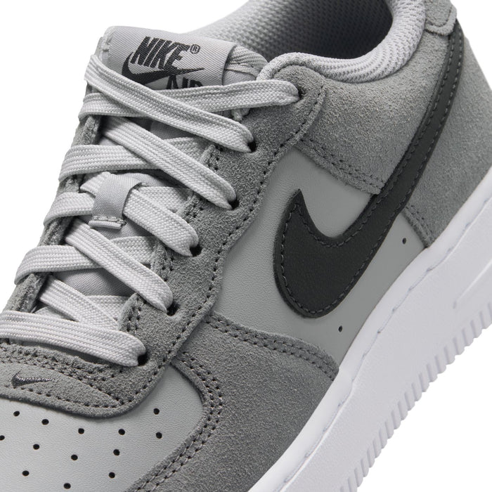 Youth Air Force 1 sneakers, close-up, smoke gray suede with white laces and Nike logo