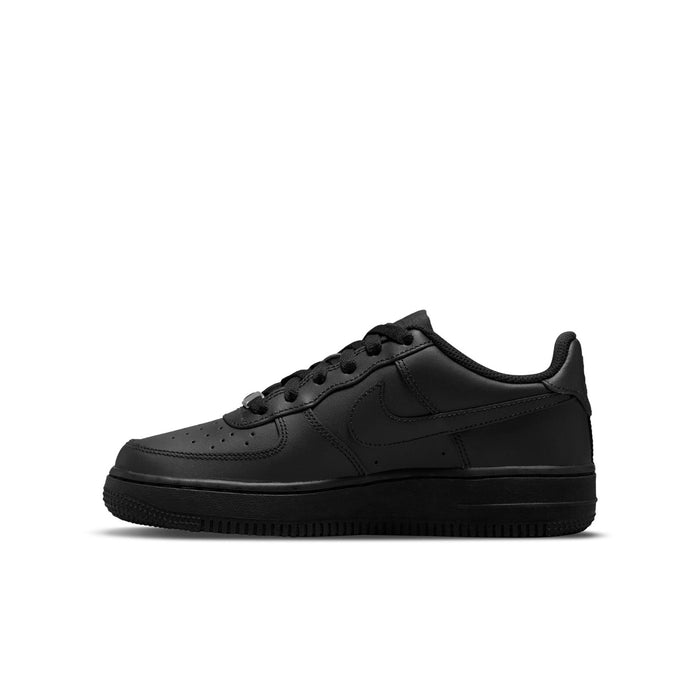 Black youth low-top sneaker with swoosh and perforated toe box; side view