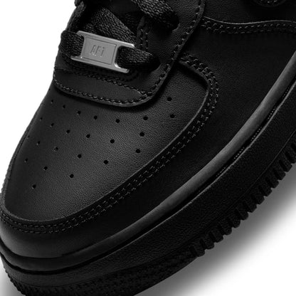 Black leather youth sneaker close-up of laces, perforated toe, and stitching