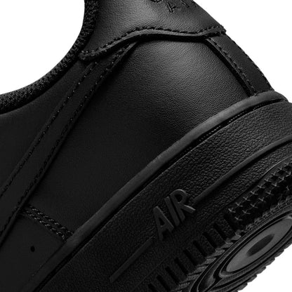 Black youth sneaker close-up of side panel and AIR sole lettering; swoosh edge