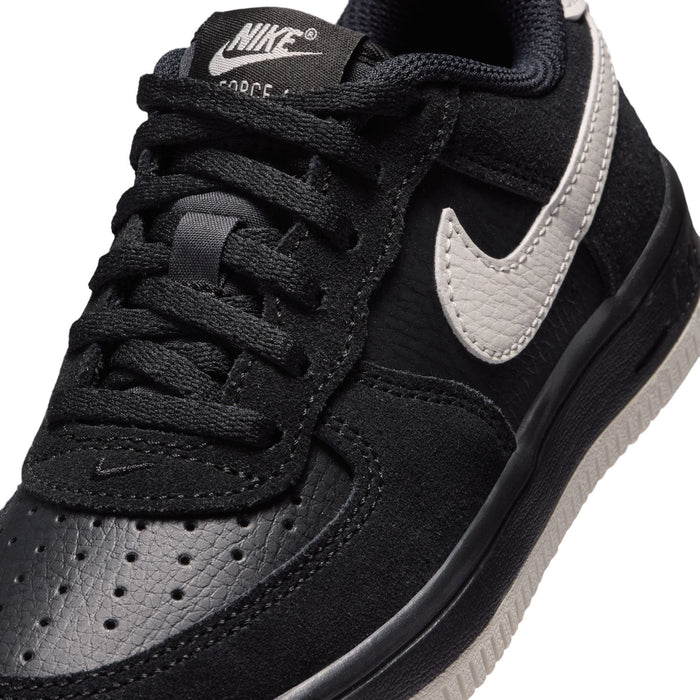 Kids Air Force 1 lace sneaker close-up, black upper with light bone swoosh