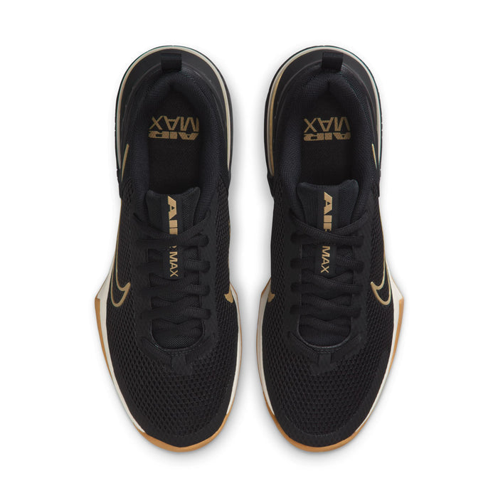 Black low-top sneakers with gold accents and lace-up front