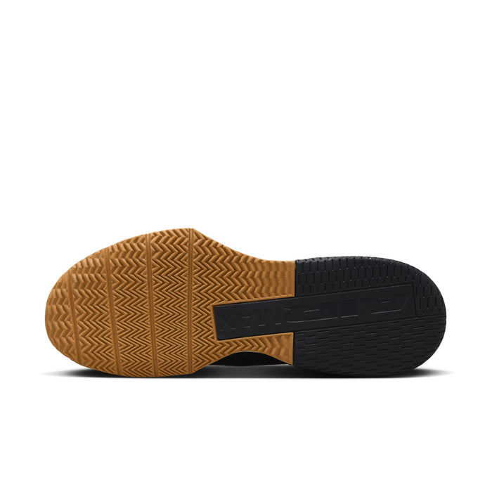 Black and tan outsole view of athletic sneaker with textured rubber tread
