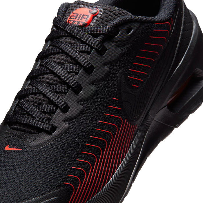 Close-up men's black knit sneakers with red wave laces and Air Max logo patch
