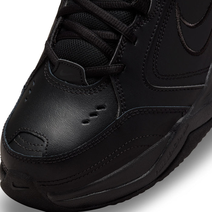Men's black sneaker toe area with textured leather and stitched panel