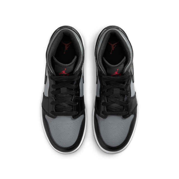 Pair of youth mid-top sneakers showing toe and laces; black, gray, white with red lining
