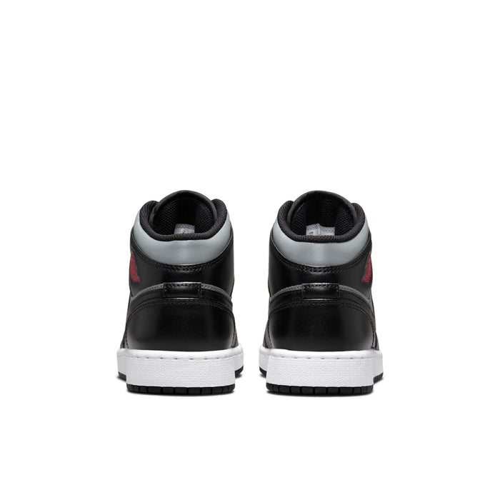 Youth mid-top sneakers heel view in black and gray with white midsoles and tread