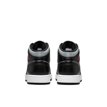 Youth mid-top sneakers heel view in black and gray with white midsoles and tread