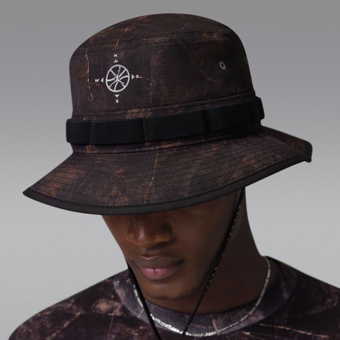 Dark brown/olive bucket hat with compass logo on side and black chin strap