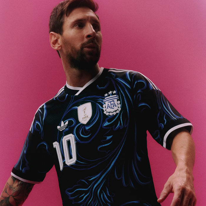 Black jersey with blue swirl graphics, white number 10 and AFA badge on front