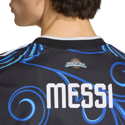 Black jersey collar with Argentina badge and blue swirls; large white MESSI graphic