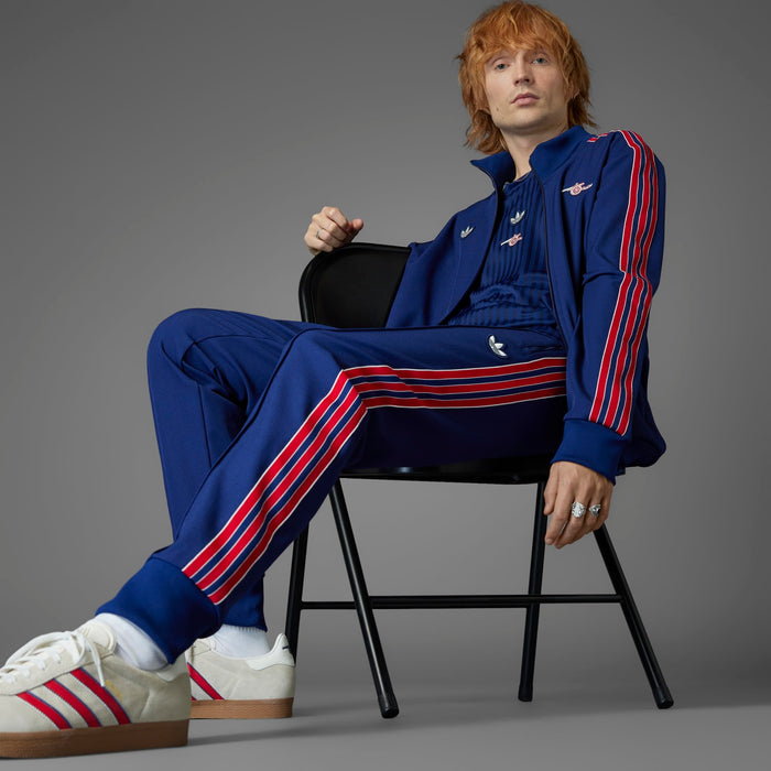 Men’s blue track pants with red/white stripe accents and embroidered logo
