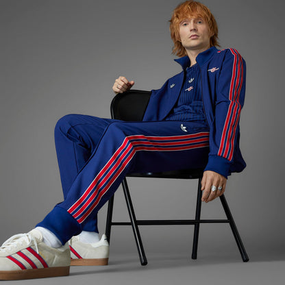 Men’s blue track pants with red/white stripe accents and embroidered logo