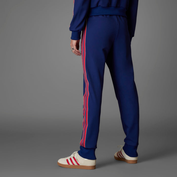 Men’s blue track pants with red and white stripe down the sides and cuffed hem