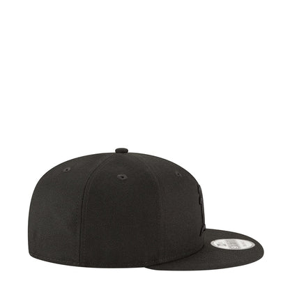 Black baseball cap with curved brim and stitched panels, side view