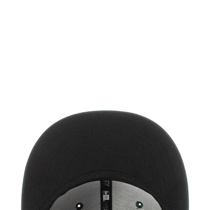 Black baseball cap interior with size tag near brim opening