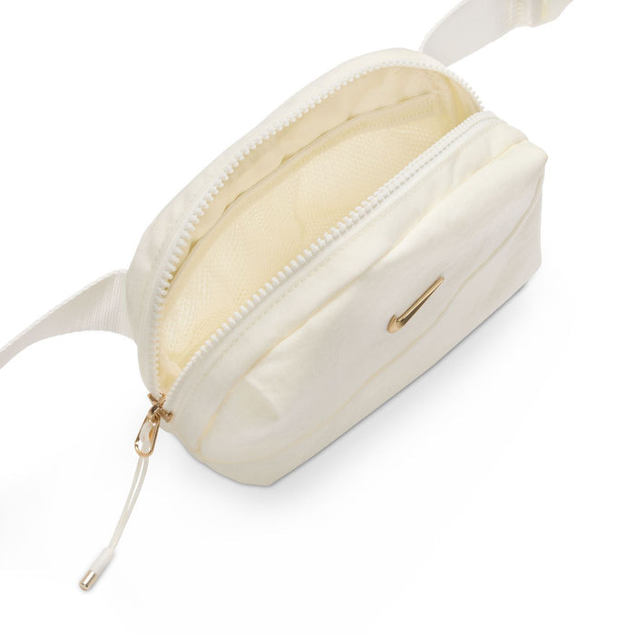 Cream oval crossbody bag side view with zip opening, interior pocket, and gold pull