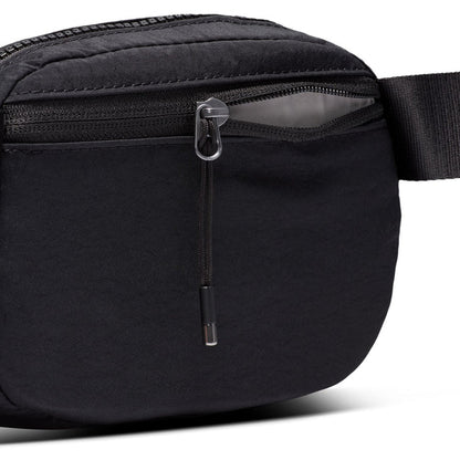 Close-up of black crossbody bag zipper with metal pull tab and textured trim