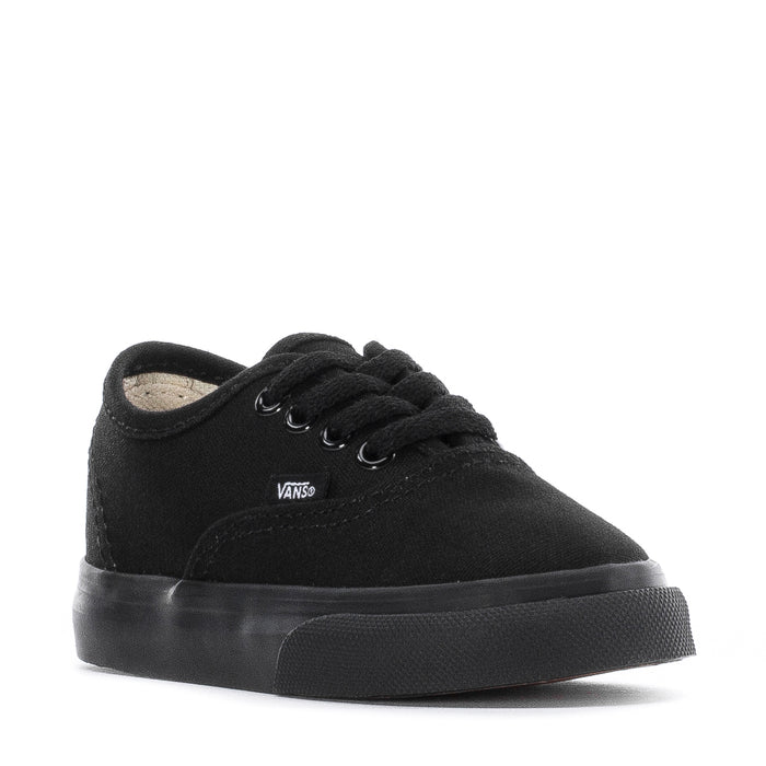Toddler black low-top sneakers, front view with lace-up eyelets and Vans tag