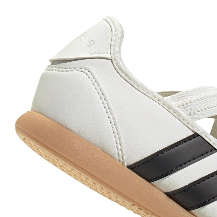 Youth Mary Jane sneaker close-up, white upper, black stripe accent, tan gum sole.