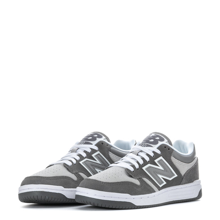Youth New Balance pair of gray low-top sneakers with white laces and midsole