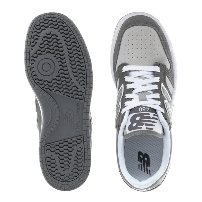Youth New Balance sneaker view: textured rubber outsole tread and gray heel collar with laces